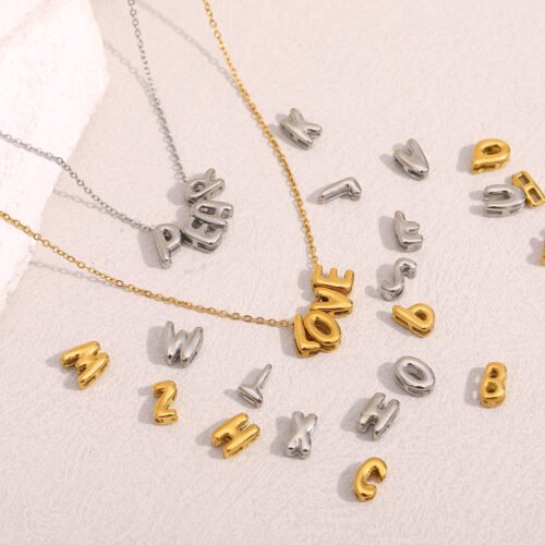 Bubble letter slider charms threaded on gold chain necklace