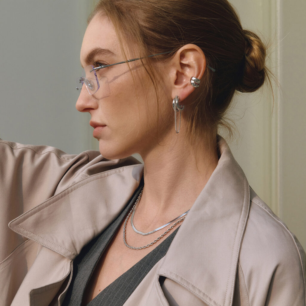 layered gold silver hoop earrings on ear