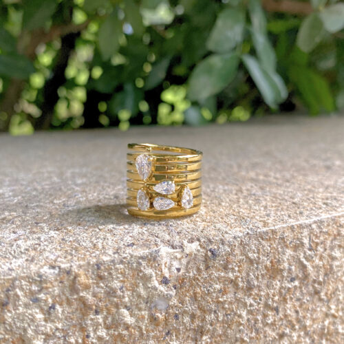 gold layered band statement ring with pear cut zircon sparing ring