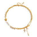Gold safety pin necklace with pearl accents, heart cubic zirconia links, cross charm, star pendant, and chunky chain details