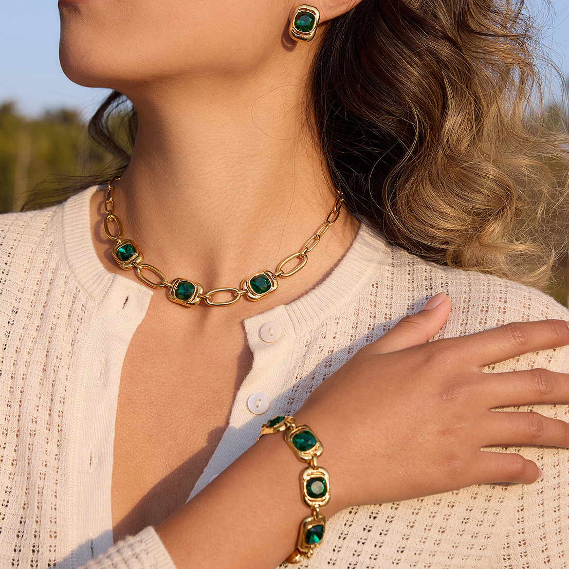 Mara green CZ bracelet worn with gold jewelry
