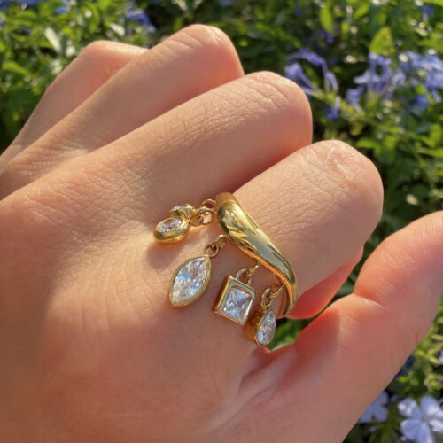 Golden Wishes gold CZ dangle ring with five sparkling cubic zirconia charms in heart, round, pear, marquise, and square shapes.