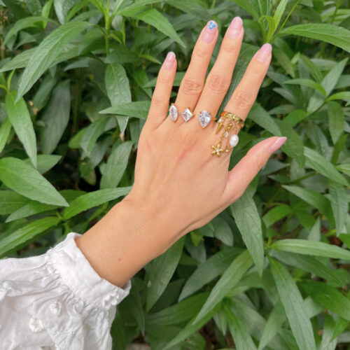 Poppy Charm Ring in gold with pearl safety pin, dangling flower charms and cubic zirconia detail