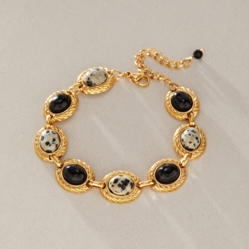 Gold oval stone link bracelet with black and speckled accents