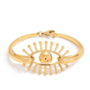 Gold evil eye bracelet with a radiant sunburst design in gold-tone stainless steel