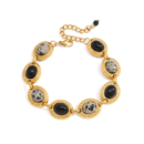 Gold oval stone link bracelet with black and speckled accents