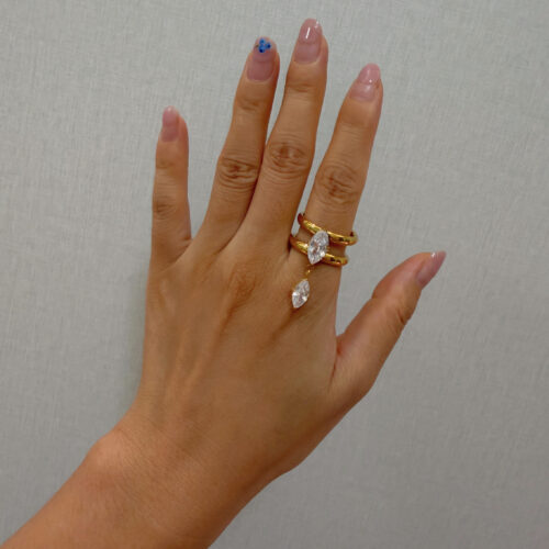 Lola Ring in 18K gold-plated stainless steel with marquise-cut cubic zirconia stones and a dangling CZ accent