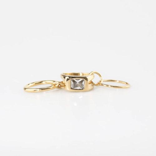 Gold stackable ring with linked bands and rectangular-cut cubic zirconia