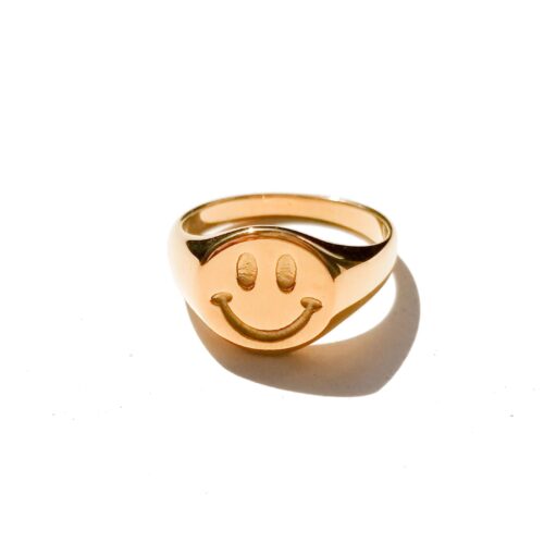 Gold smiley face signet ring with a chunky polished stainless steel band