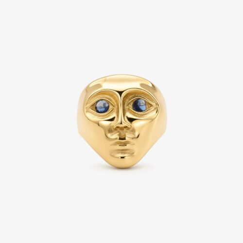 Gold face ring with blue zirconia eyes and a sculptural gold-tone design
